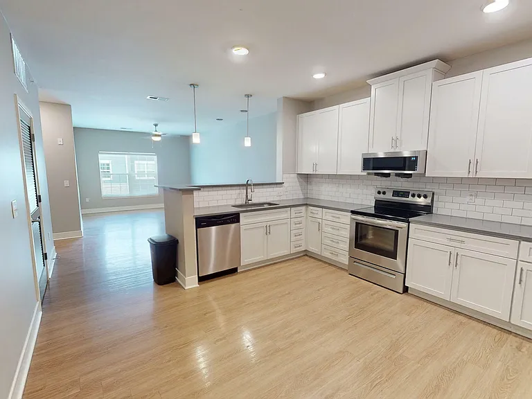 The kitchen opens into the large living room. The kitchen opens into the large living room.