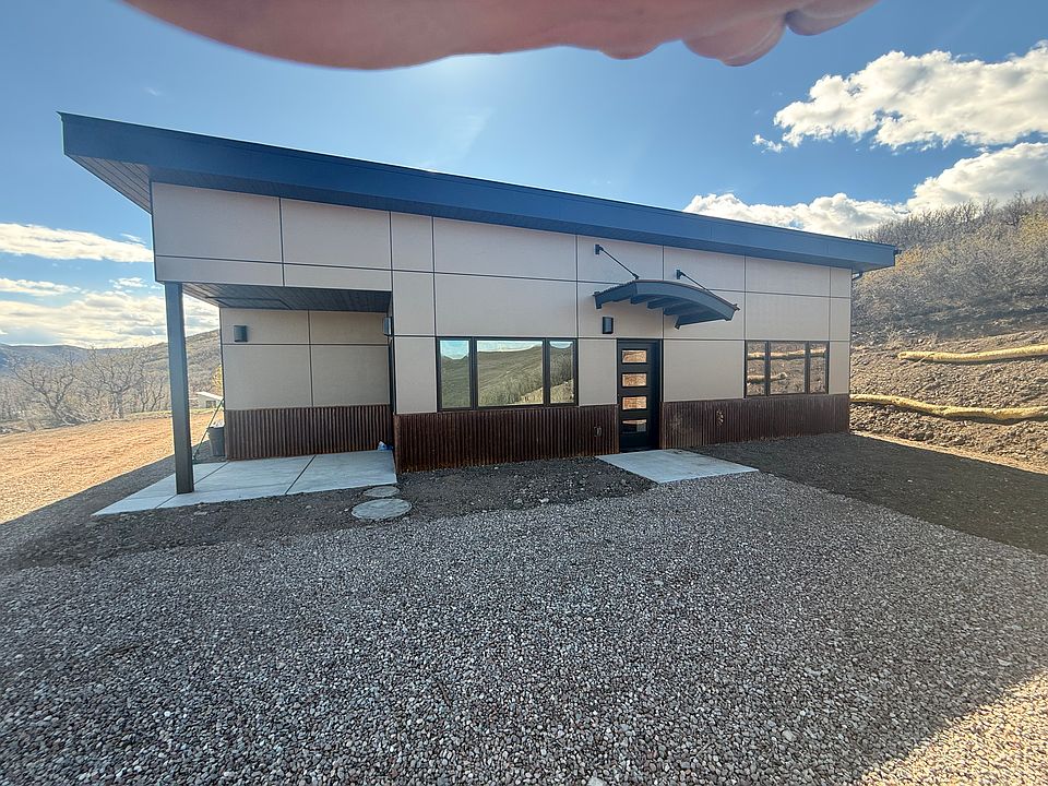 Front entrance from parking area showing patio overlooking the valley to the west and north.