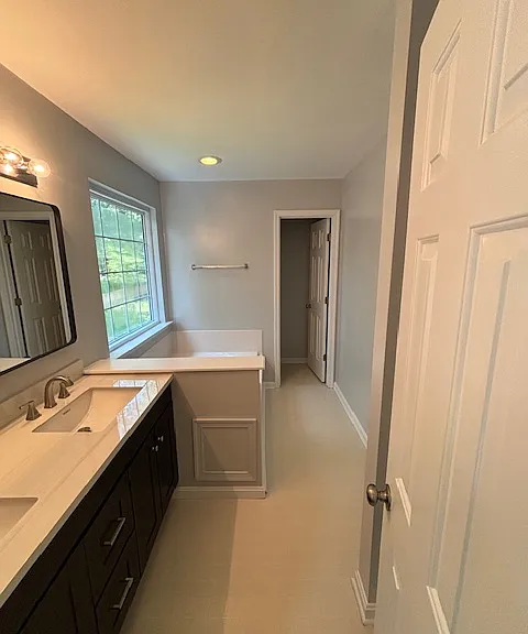 Jack and Jill sinks with granite countertop. Oval tub. Walk-in shower (to the right behind the door). Privacy toilet room!