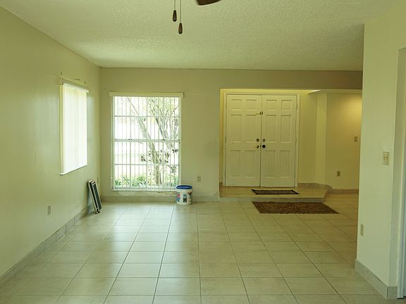 Looking from dining room to living room and entrance door