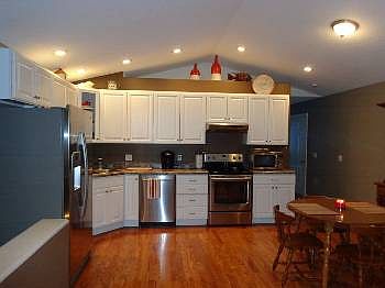 Kitchen open to the living room. Outstanding colors make this area really pop. Stainless steel appliances are included.