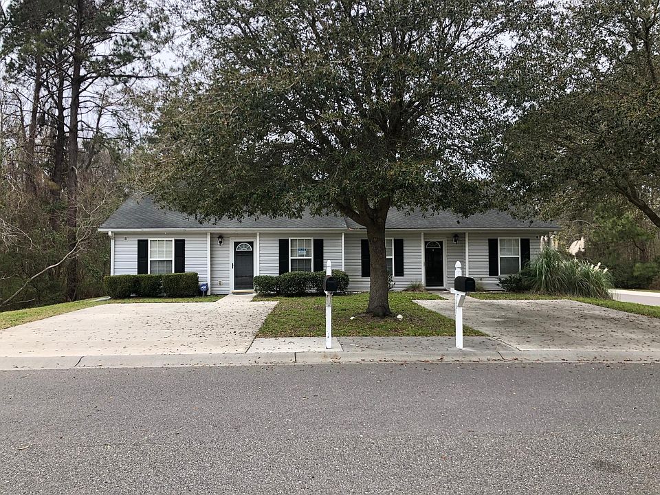 Welcome to 1679 Dexter Lane! The townhome is on the left next to a beautiful private wooded area.