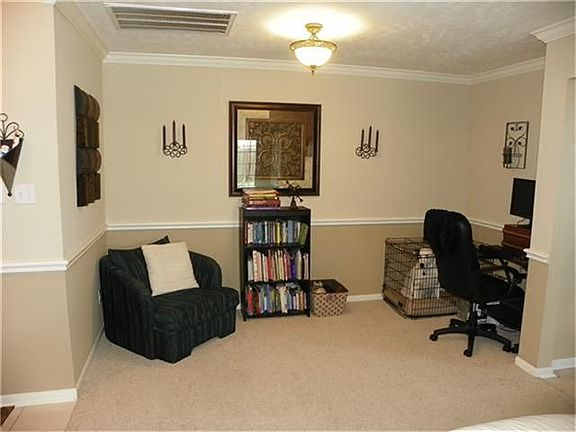 The dining room has crown molding accents and two tone paint for a truly custom finish