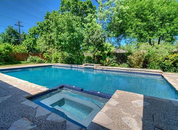 In the evening, come home from work and slip into the soothing warm water of your private spa.  Then relax and dry off on the patio while listening to the tranquility of the trickling of the waterfall at the other end of the pool and enjoying a glass of w