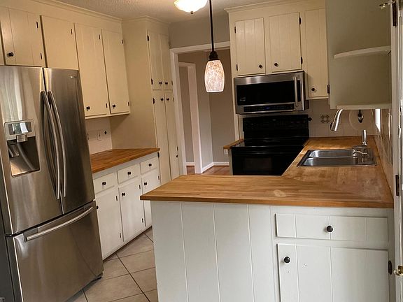 Kitchen with easy to maintain butcher block countertops.