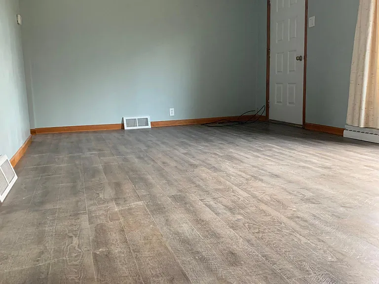 Enormous living room with large picture window to the front yard