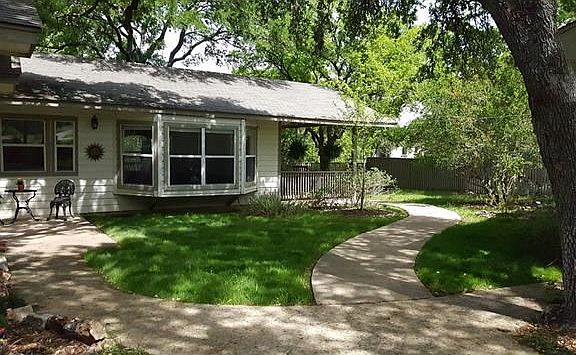 Sidewalk from front of house. Left fork leads to separate entrance and right fork leads to front cov