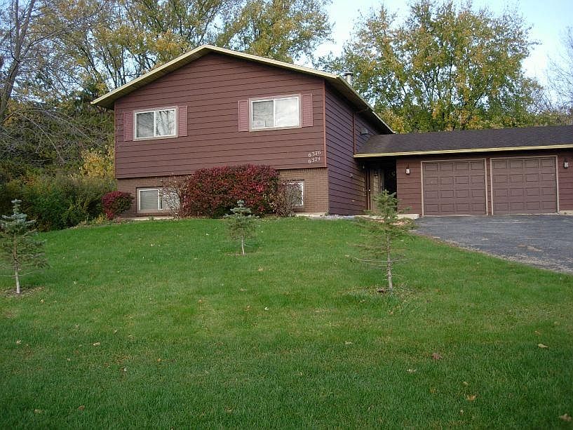 Front yard, duplex is on a 1/2 acre lot, newly paved driveway & windows in 2021 (not pictured)