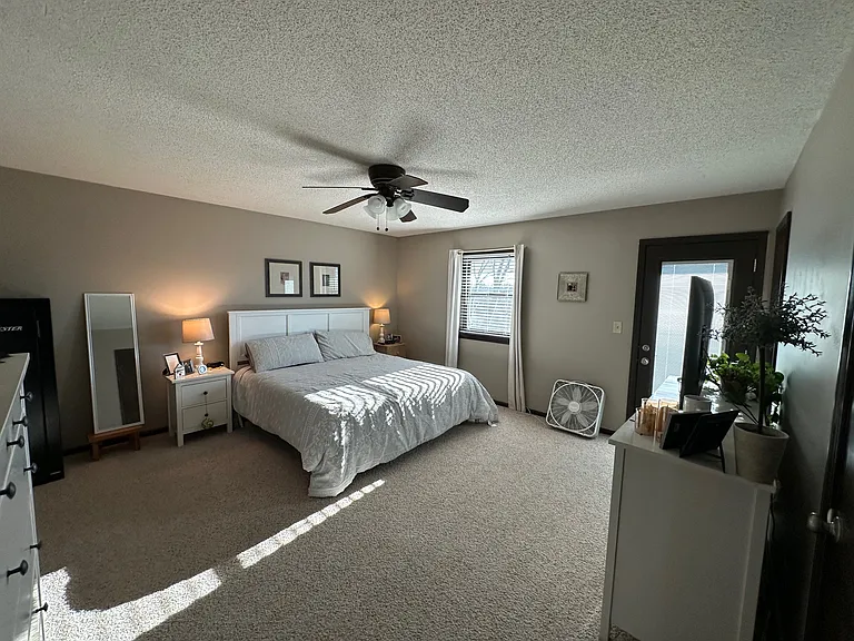The spacious primary bedroom offers plenty of room to relax, along with the convenience of two closets and a private en suite bathroom. A separate door opens directly onto a private deck _ the perfect spot to start the morning with a good cup of coffee.
