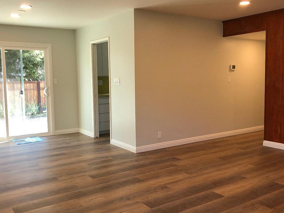 Looking to the kitchen and backyard from living room.