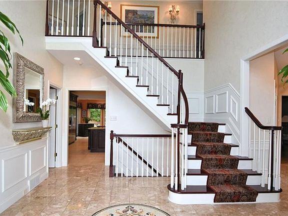 Foyer - Ceramic tile flooring, turned staircase, wainscoting.