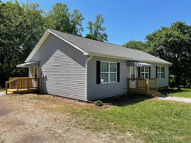 Left-side view of home with covered raised side entryway landing. - 3947 Anderson Mountain Rd