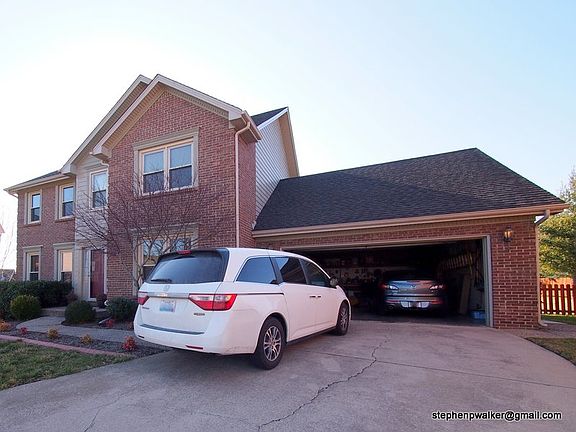 Large 2 car garage, long with built-in work benches.
