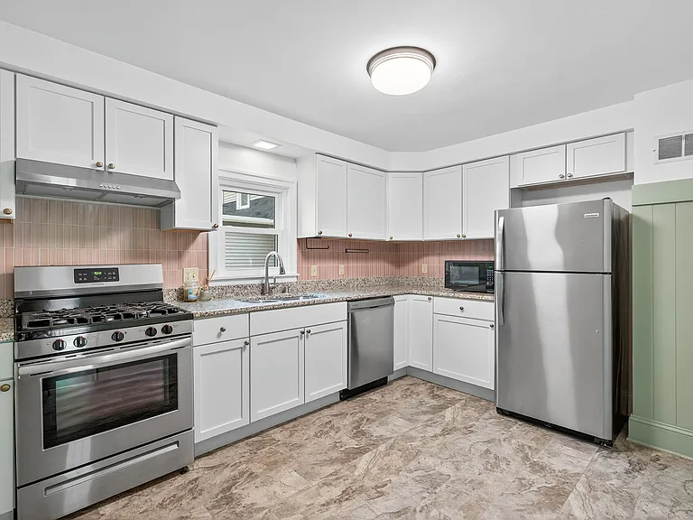 Updated Kitchen with stainless steel appliances and abundant cabinet space.