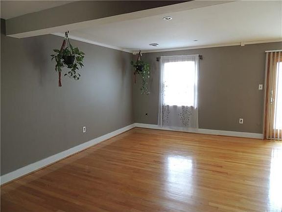 Family Room with Crown Molding and High Baseboards