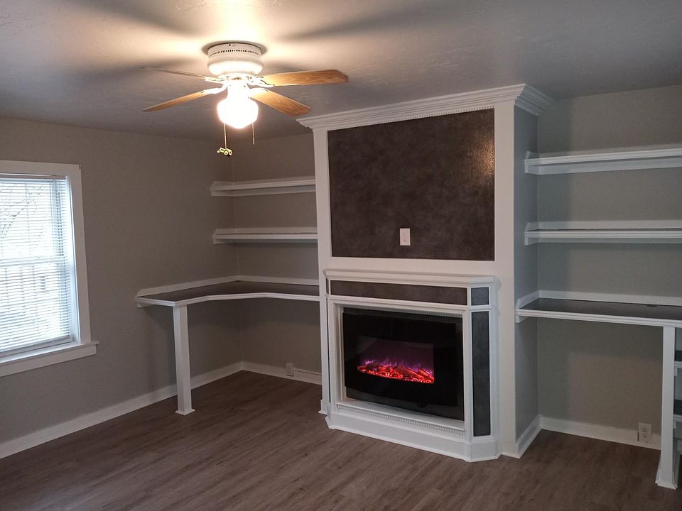 large living room with fireplace and built-in shelving