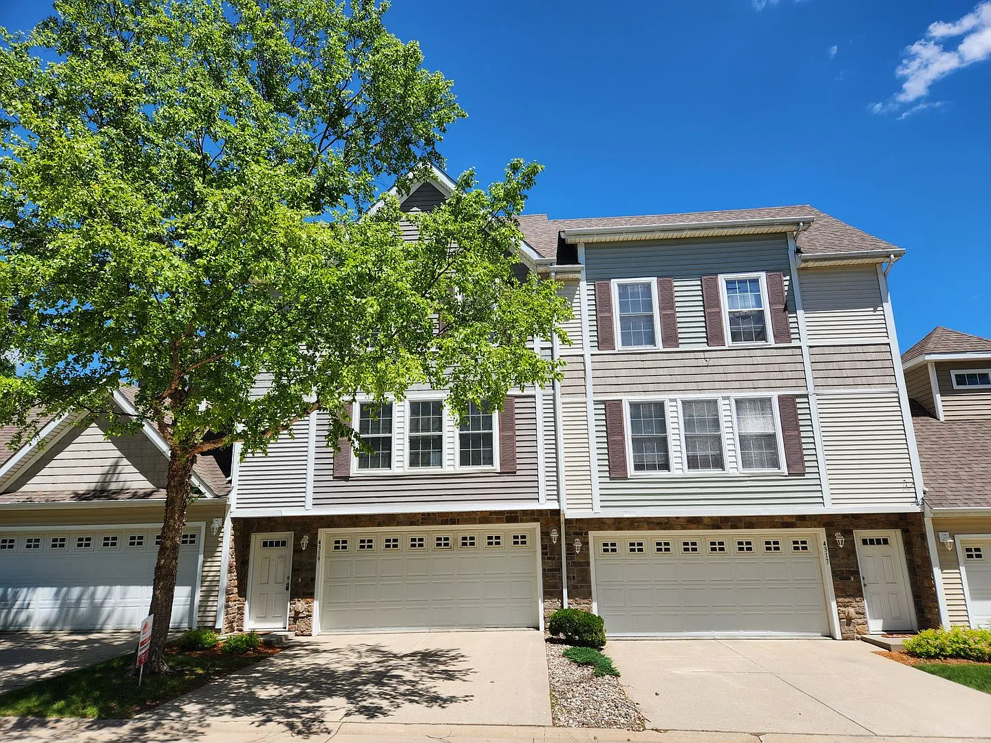 Now $1,550! Spacious Urbandale Townhome with 2-Car Garage, Deck & Lawn Care Included — Photo 1