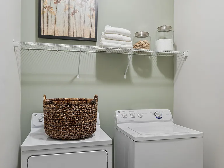 Experience the charm of this efficiently organized laundry room, blending style and practicality.
