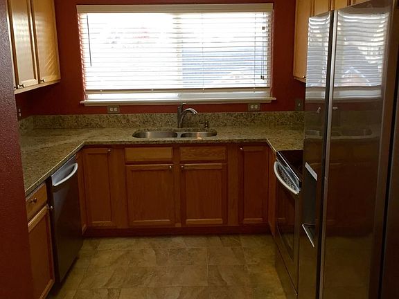 Kitchen with top of the line stainless steel appliances and large window