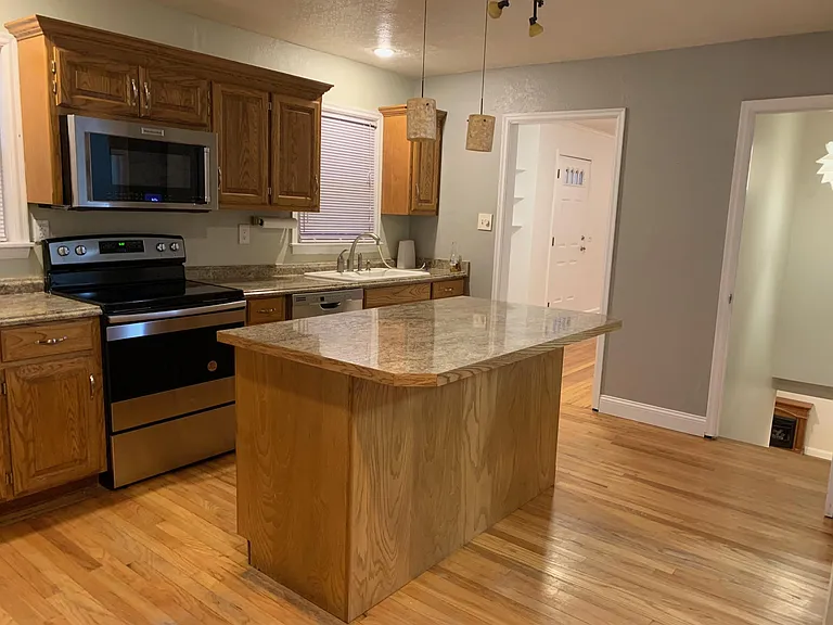 Large kitchen with stainless stove and convection oven/microwave combo, large island