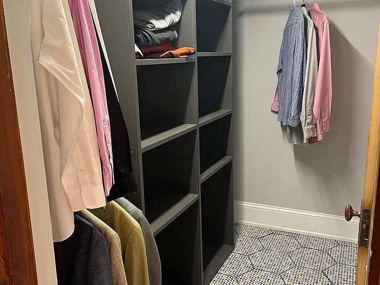 Walkin closet between the bathroom and bedroom.