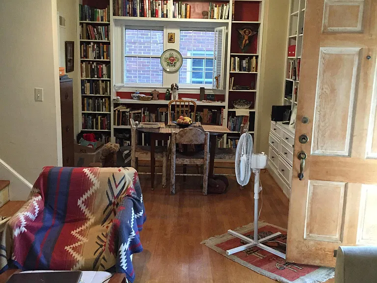 View into Dining room area. Full built in bookcases which continue behind obscured view behind door.