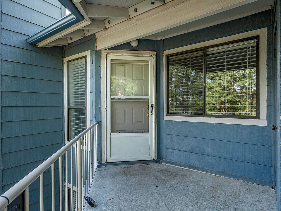 Front door and balcony area. There is room for a small table and chairs. There is also a storage closet.
