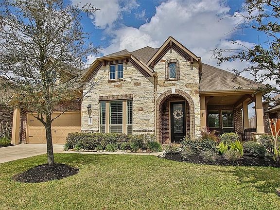 Lush landscaping lends a beautiful curb appeal to the home and greets you as approach the half wrap around porch!