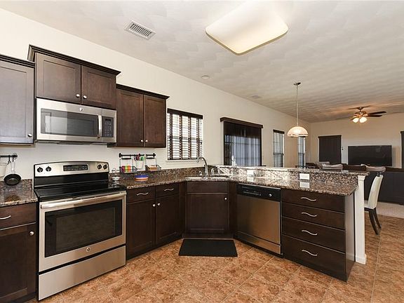 Beautiful espresso cabinets, stainless steel appliances, granite counter tops and ceramic tiled floor.