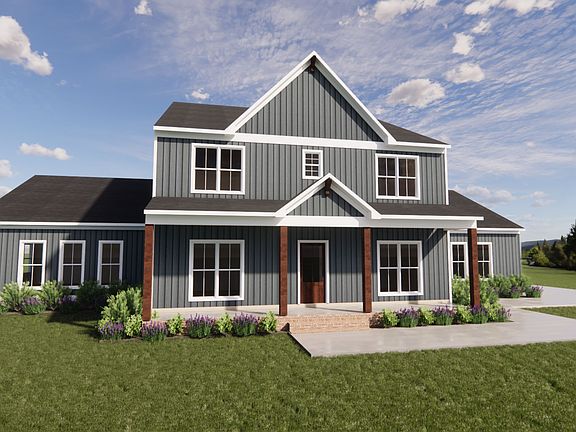 A modern two-story blue house in Scotchtown Estates, with a manicured lawn and surrounded by trees u
