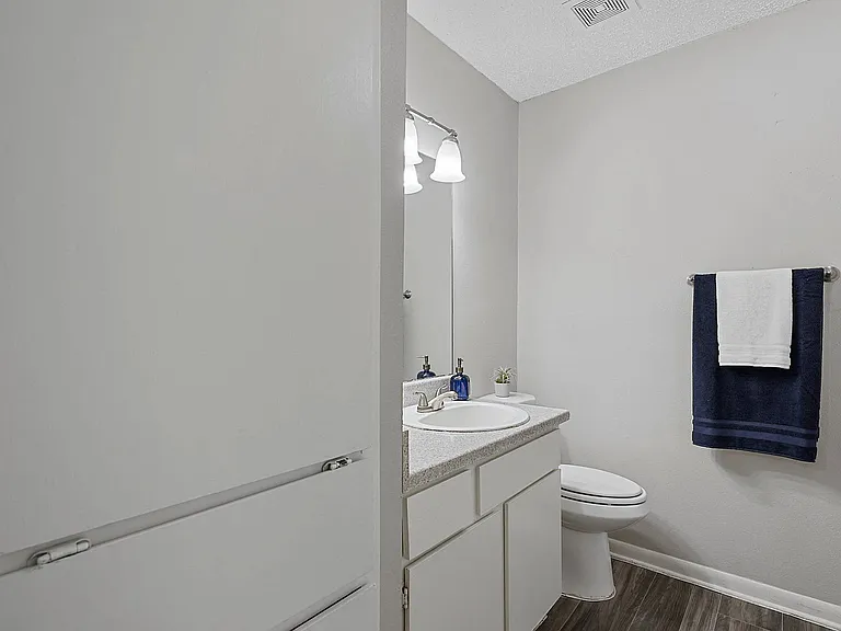 Enjoy a clean, modern bathroom featuring sleek lighting and updated finishes.