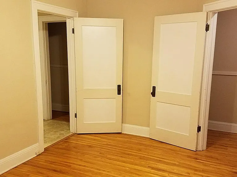 Main bedroom. Kitchen to left. Hallway door open.