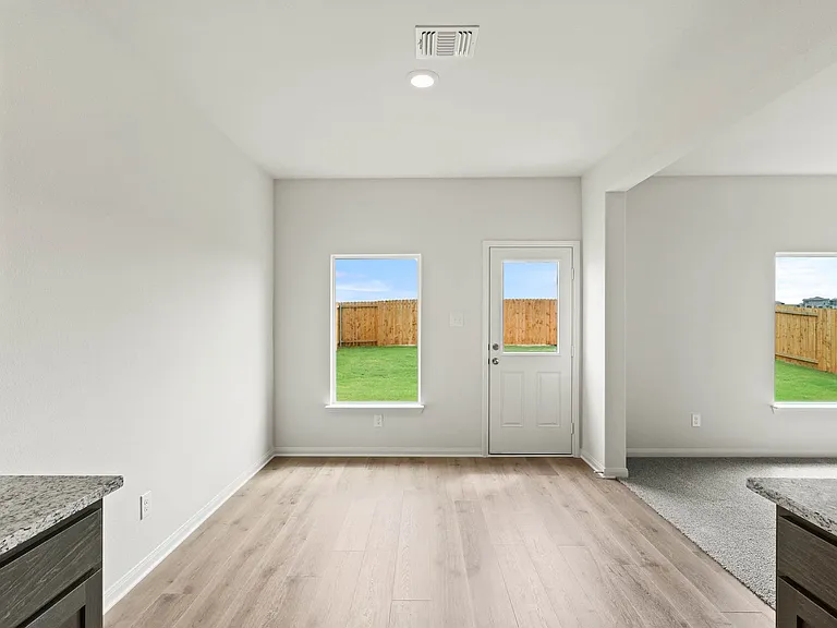 The dining room sits right off of the kitchen has a large window.