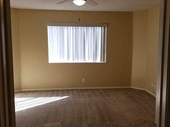 Larger master bedroom with ceiling fan and walk in closet