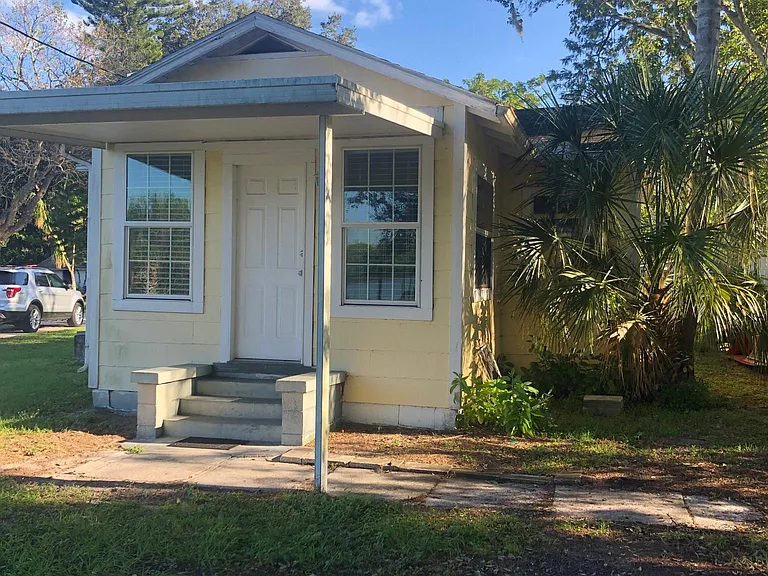 older front, before landscaping, driveway and new paint