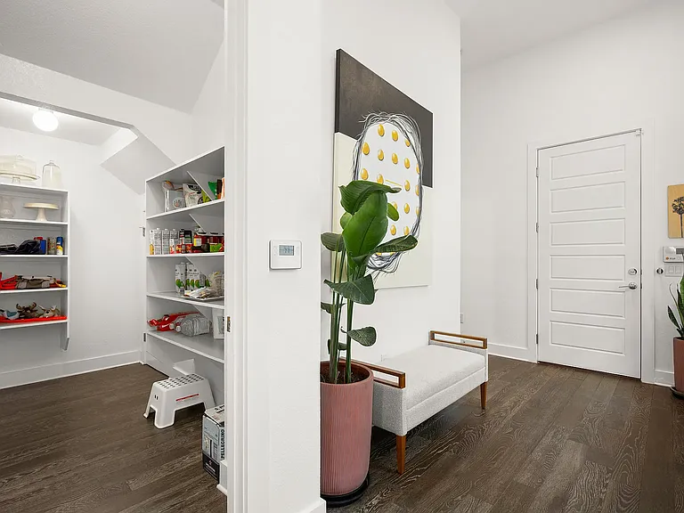 An oversized walk-in pantry offers exceptional storage, complete with under-stair space_one of the largest pantries you'll find in a home this size!
