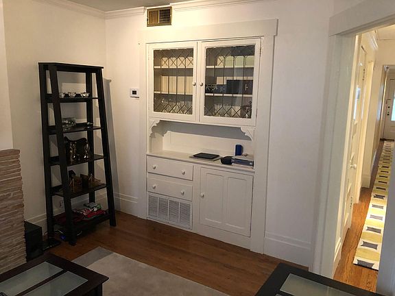 Period detail including crown moulding and built-in hutch with leaded glass.