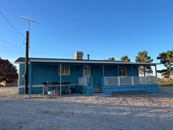 Front of home with covered carport with EV Cahrger and large-spacious patio deck
