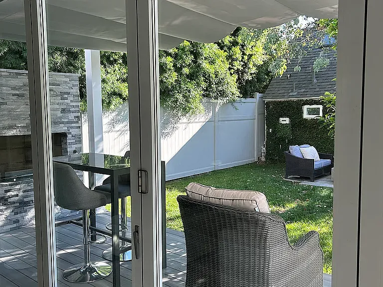 Collapsible glass wall opens up from Great Room to outside deck and fireplace