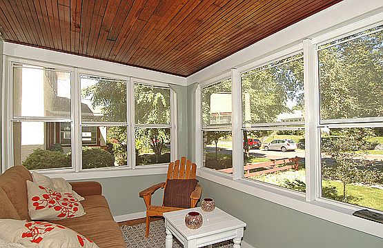 Sunny front porch was recently rebuilt, complete with new windows and floor. 