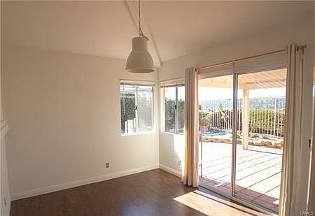 Conveniently located off the kitchen, the dining room is complete with chic designer light fixture, and direct access to back patio. Perfect for hosting an indoor-outdoor soire_.
