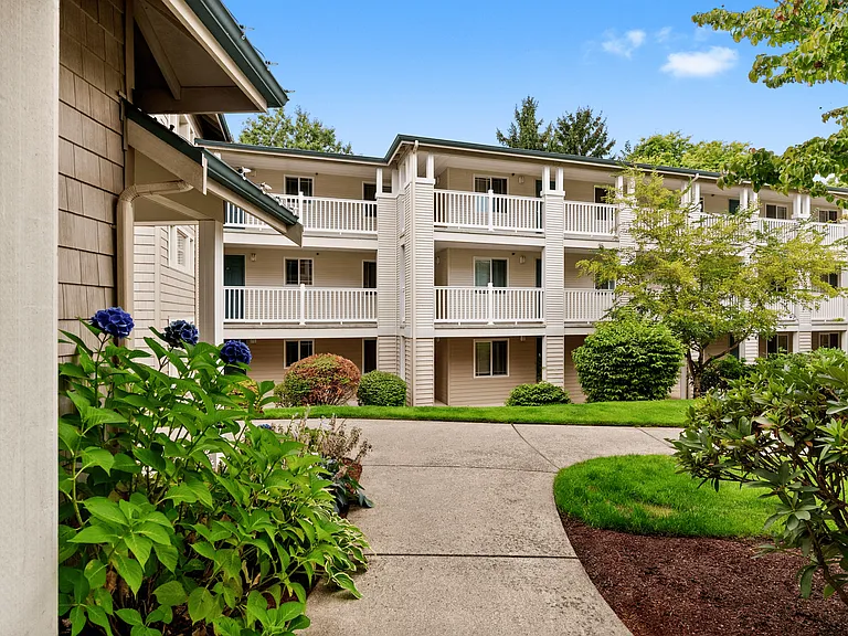 Bright flowers and lush landscaping create a welcoming path home.