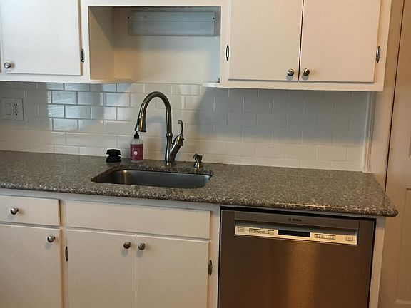 Stainless steel appliances. Granite countertop, hard wood floor.