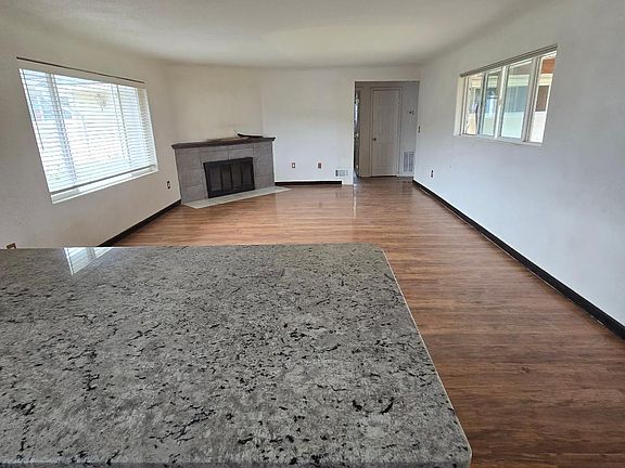 Kitchen looking towards fireplace, hallway and bedrooms.