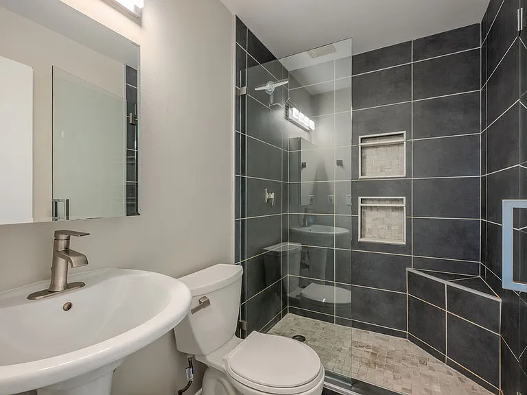 updated bathrom with nice shower and glass doors
