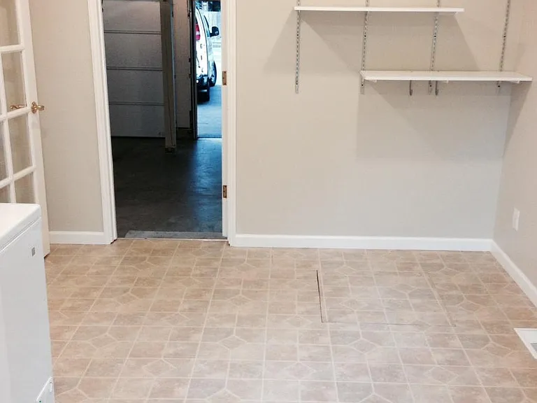 laundry room off kitchen connected to garage