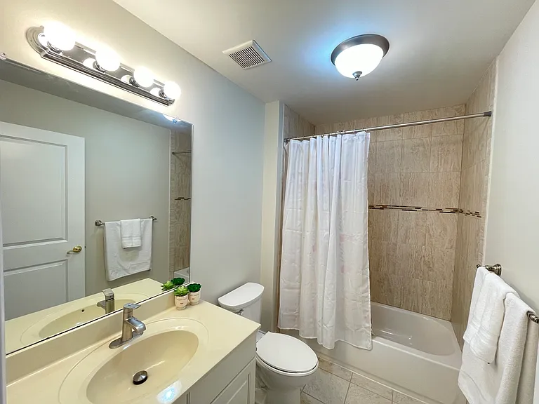 Spacious main bath featuring elegant finishes and natural light