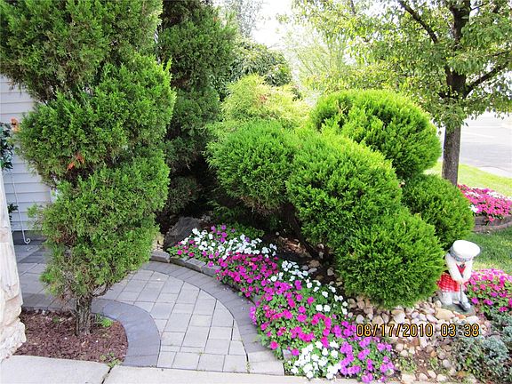 Brick Paver Walkway Lined with Flowers to Etched Glass Entry