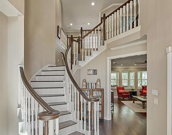 The stunning wood staircase. There is crown molding throughout the whole home.
