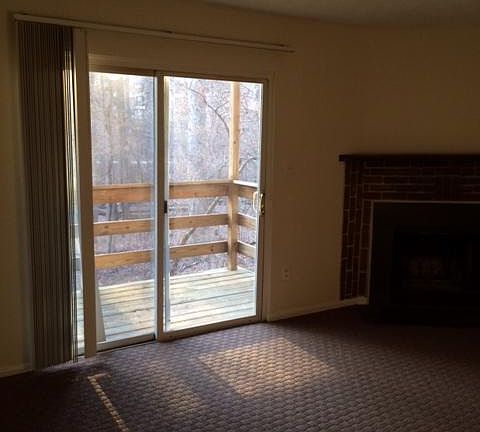 Living room & fireplace & sliding glass doors to balcony